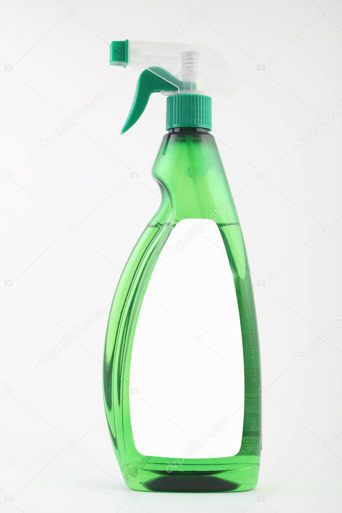 green plastic bottle with green spray nozzle, detergent for home frill isolated empty mock up on white background