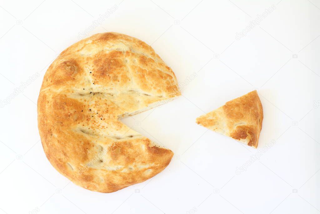 Slices of Ramadan Pita (Ramazan Pidesi) Traditional Turkish bread for holy month Ramadan on white background. Ramadan concept.