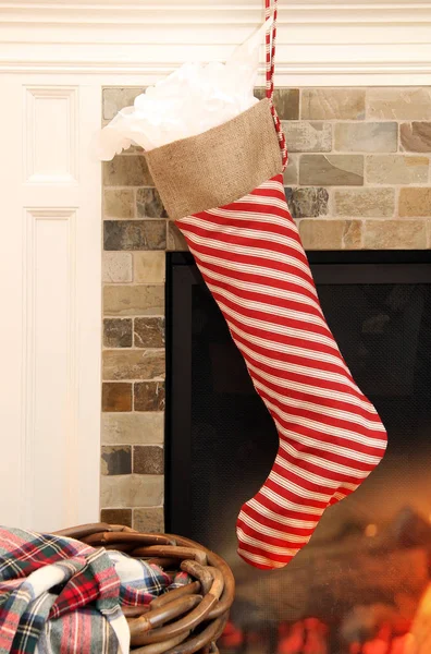 Christmas stocking by fireplace — Stock Photo, Image
