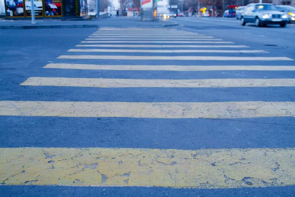 Yellow stripes on asphalt road