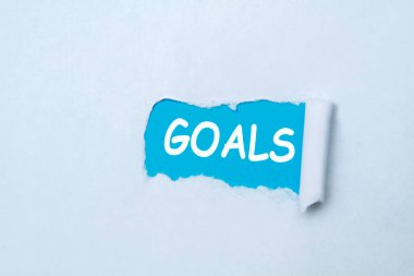 Gözyaşları altında yazılmış hedefler katlanmış kağıt, mavi ve beyaz. 