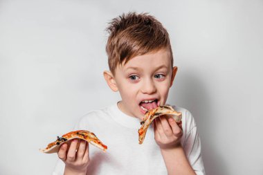 Büyük bir zevkle bir dilim pizza yiyor.