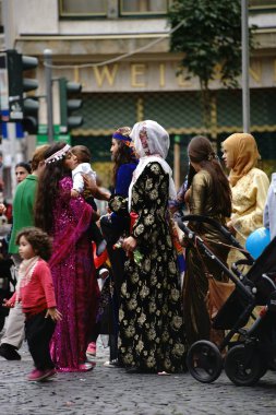 Festive Kurdish women's costumes / Kurdish women with children and family present colorful costumes at an Intercultural Week event on September 25, 2015 in Mainz.              clipart