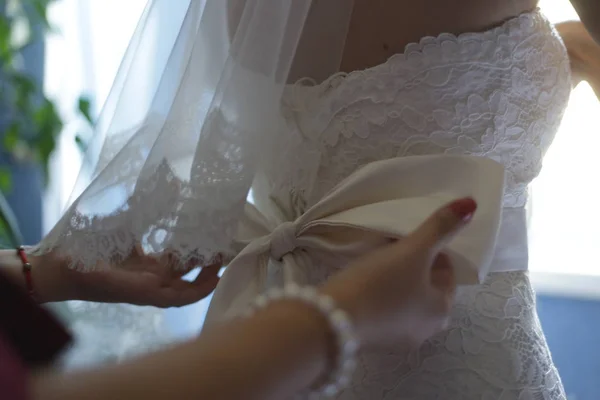 bridesmaid dresses a bow on a bride\'s dress