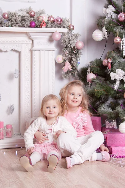 Two Girls Hug Laugh Fireplace New Year Tree — Stock Photo, Image