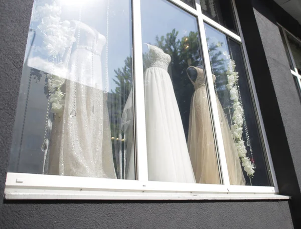 wedding dresses displayed in window showcase