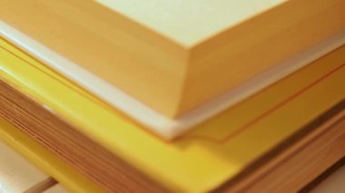 Kitap yığını, üzerinde sarı kurumuş nergis çiçeği, güzel gölgeler, aşağıdan yukarıya doğru tava