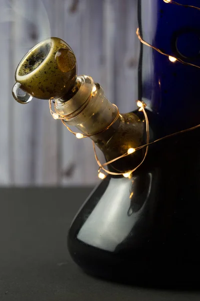 Blue bong with small lights wrapped around — Stock Photo, Image