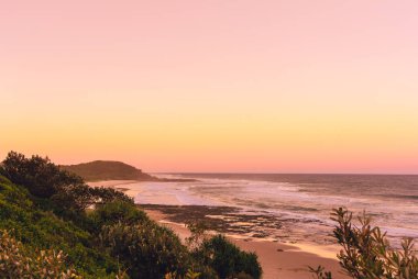 The pinky sunset in summer time on the beach in Ballina with ocean view, Byron bay, Australia clipart