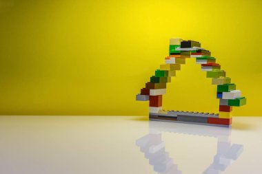 Sarı bir arka plan üzerinde bir ev inşa kavramı