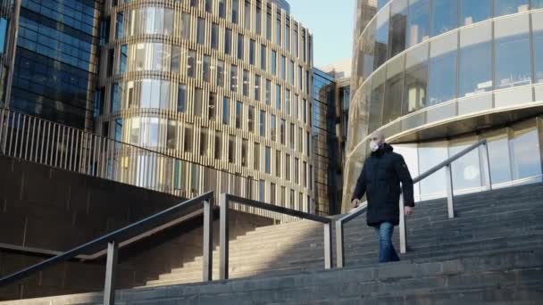 Young Guy Medical Mask Goes Stairs Background Empty Business Center — Stock Video