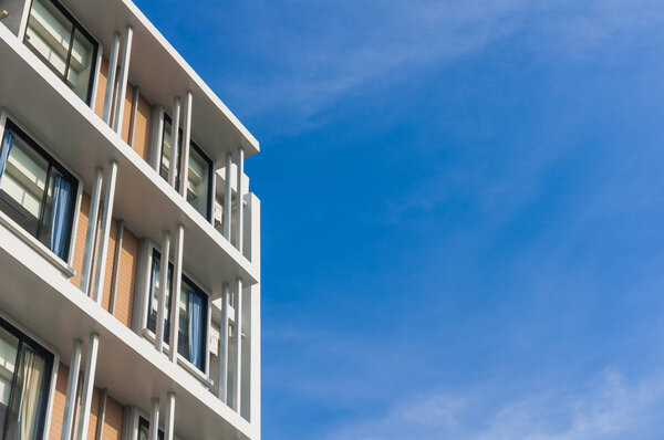 Close up part of condominium modern style on blue sky background