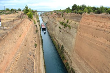 Narrow Corinth Canal between Cyprus and Greece with a tugboat and a barge in the background clipart