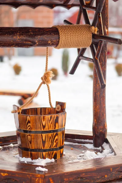 wooden well in garden. Winter