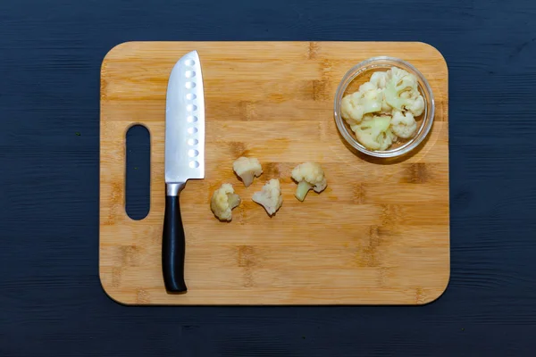 Cauliflower rice cooking cut food wooden board.