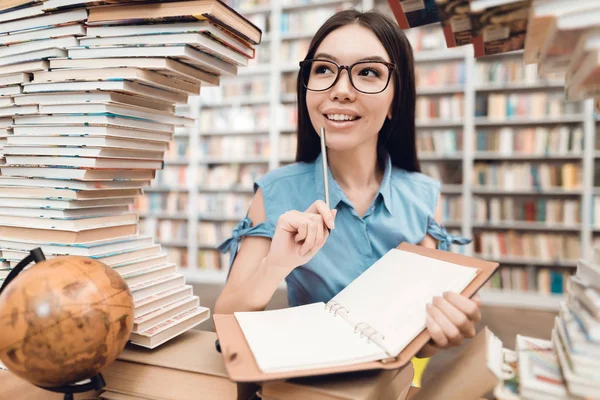 Ethnic Asian Girl Glasses Sitting Table Surrounded Books Library Writing — Stock Photo, Image