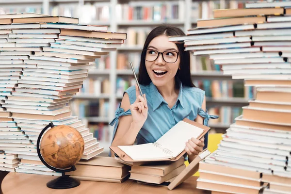 Ethnic Asian Girl Glasses Sitting Table Surrounded Books Library Writing — Stock Photo, Image