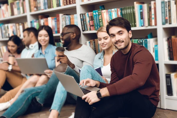 Grupo Estudiantes Étnicos Multiculturales Sentados Sonriendo Hablando Cerca Estanterías Biblioteca — Foto de Stock