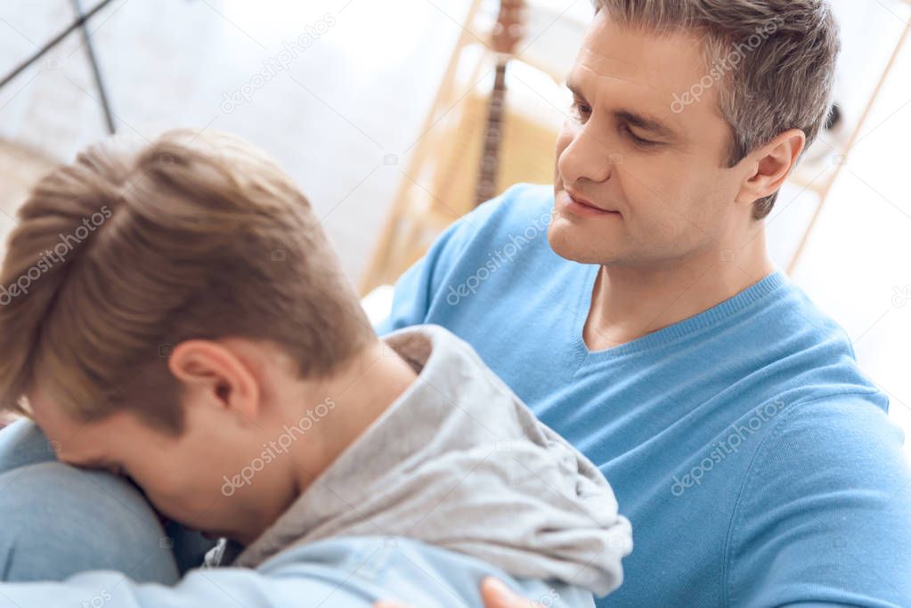 Father trying talking with son but teenager refuse listening