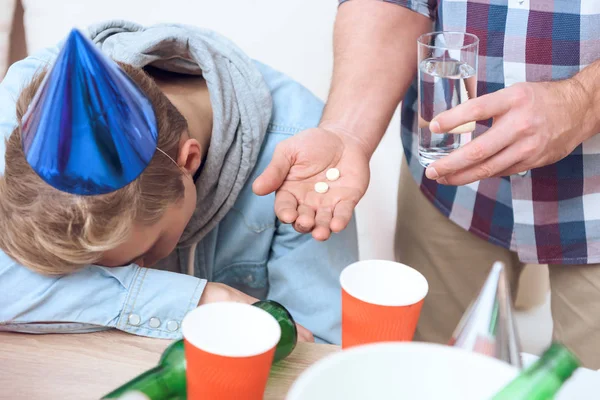 Son Having Headache Birthday Party Father Giving Him Glass Water — Stock Photo, Image