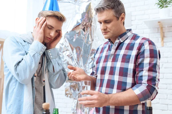 Son Having Headache Birthday Party Father Holding Glass Remedy — Stock Photo, Image