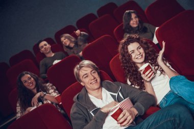 İnsanlar sinemada oturup birlikte film izliyorlar..