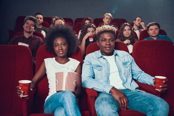 African couple with popcorn watching movie. human — Stock Photo, Image