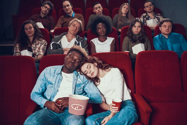 Multiethnic couple in love is sleeping in cinema. — Stock Photo, Image