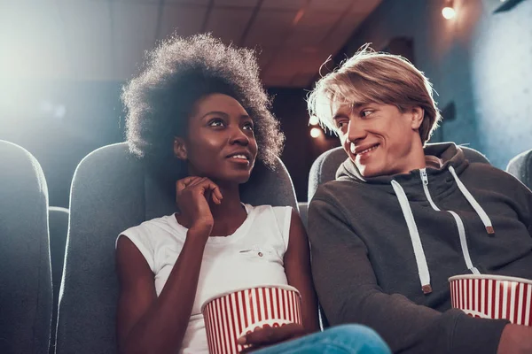 Multinational couple is watching comedy in cinema. — Stock Photo, Image