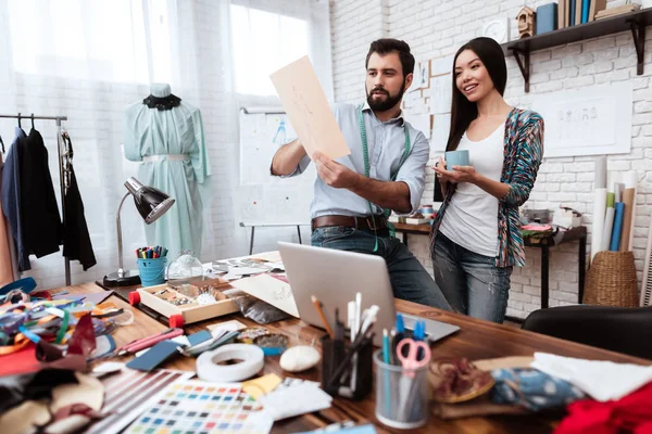 Two designers discussing working moments in tailor shop