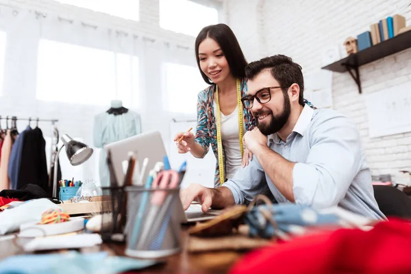 Two designers discussing working moments in tailor shop