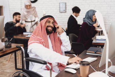 Arap adam smartphone üzerinde konuşurken tekerlekli sandalyede devre dışı