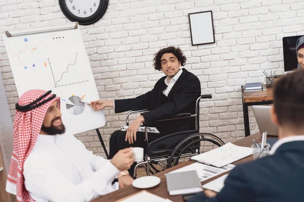 Behinderter Araber Anzug Rollstuhl Präsentiert Diagramme Auf Whiteboard — Stockfoto