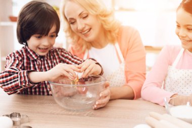 Genç büyükanne torunları kırma yumurta kase mutfak at öğretim