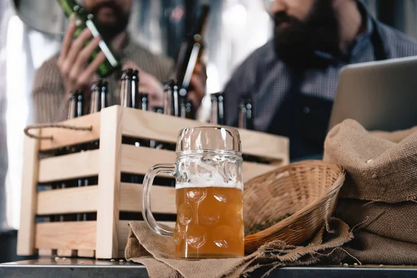 Primer Plano Vaso Cerveza Mesa Dos Hombres Recogiendo Botellas Fondo —  Fotos de Stock