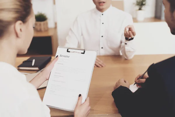 HR director woman in blouse and skirt and workers discussing resume at job interview