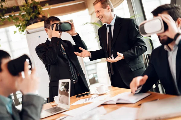 Men using virtual reality on meeting with Chinese businessmen in office