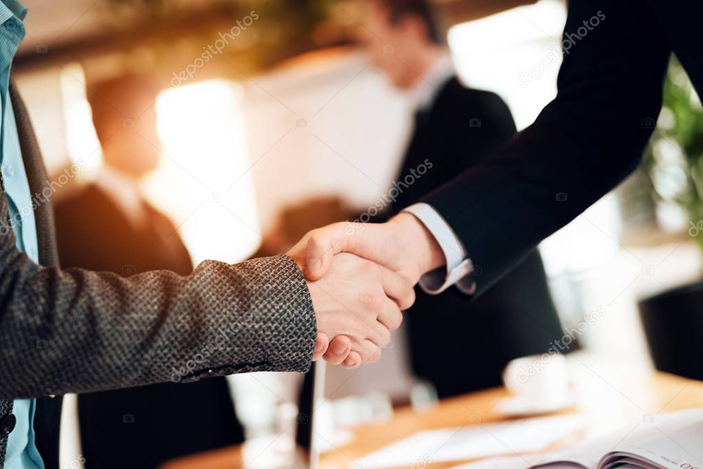 Close up of male hands shaking on businessmen meeting 