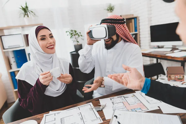 Arab man in kufiya studying house in virtual reality glasses