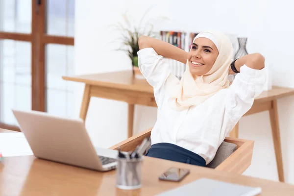阿拉伯妇女在头巾放松附近的笔记本电脑 — 图库照片