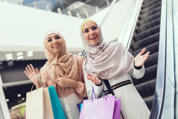 Arab women walking in mall with shopping bags