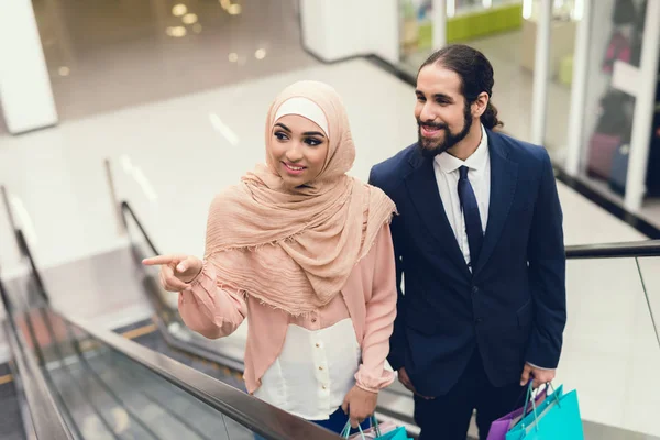 Arab man and woman walking at shopping mall