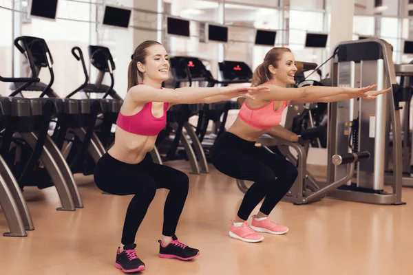 Women in sportswear doing aerobic exercises at gym
