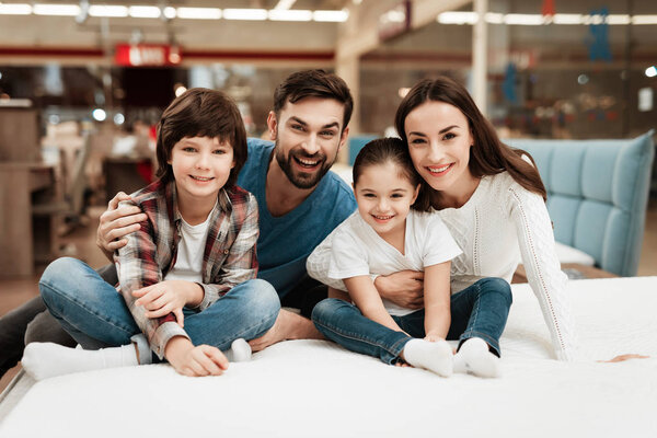 family choosing soft mattress in orthopedic furniture store