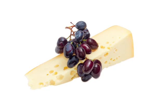 Piece of Swiss-type cheese and blue table grapes — Stock Photo, Image
