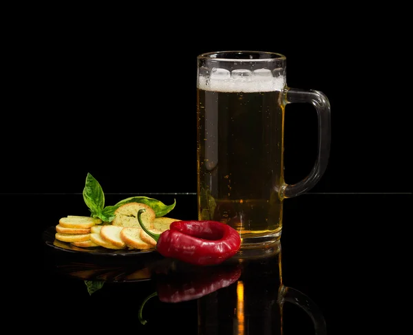 Пиво, сухари, базилик, чили на блюдце на тёмном фоне — стоковое фото