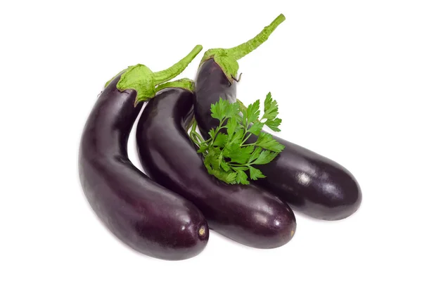Drie aubergines en peterselie takjes op een lichte achtergrond — Stockfoto