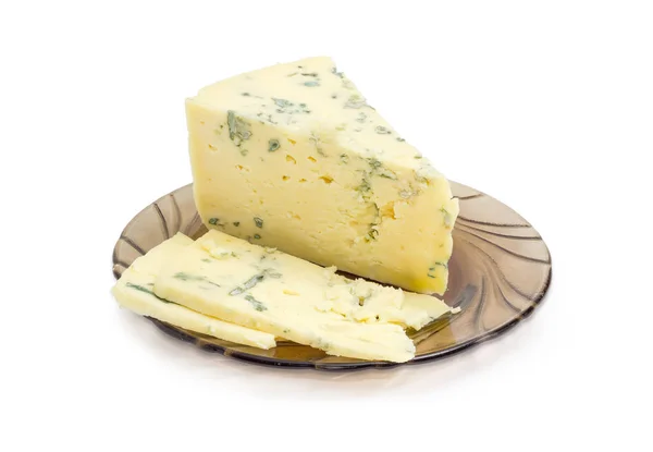 Deels gesneden blauwe kaas op een schotel van glas — Stockfoto
