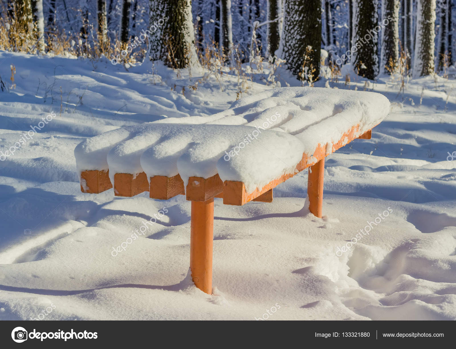 Orange Garden Bench Covered With Fluffy Snow Stock Photo