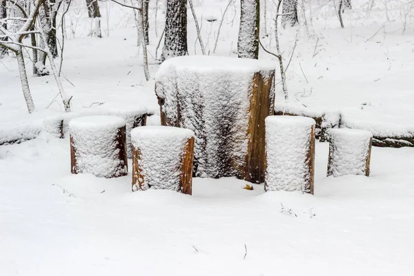 Garden furniture made from wooden log covered snow — Stock Photo, Image